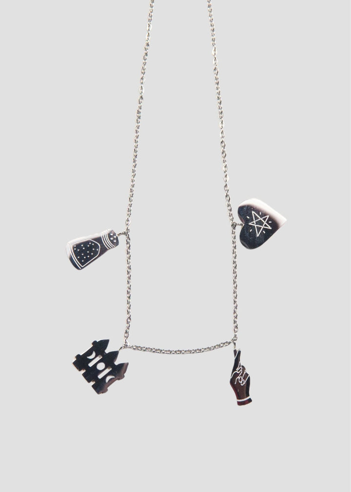 Necklace with four unique pendants on a light gray background