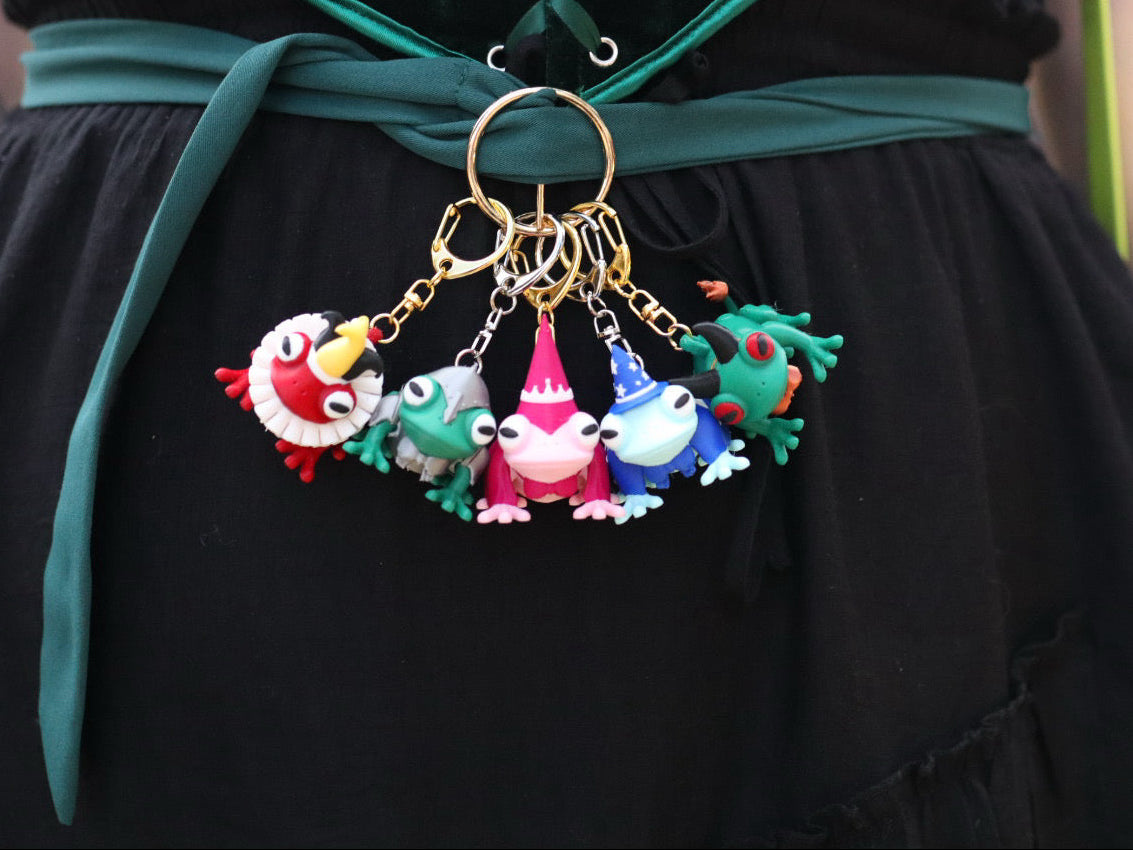 Colorful keychain with cartoon characters attached to a green and black outfit.